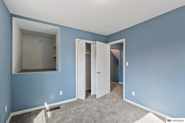 2725 Monroe St, Omaha, NE 68107 - unfurnished bedroom with baseboards, carpet flooring, visible vents, and a closet