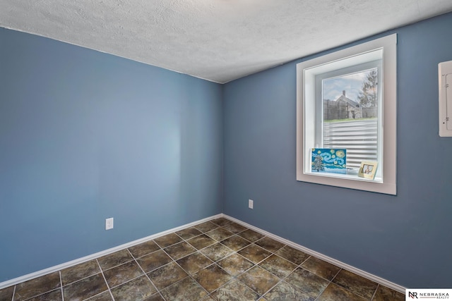 2725 Monroe St, Omaha, NE 68107 - unfurnished room with a textured ceiling and baseboards