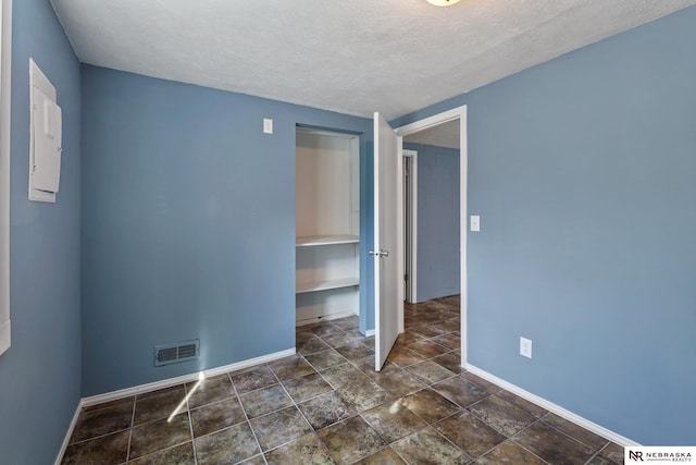 2725 Monroe St, Omaha, NE 68107 - unfurnished bedroom with baseboards, visible vents, and a textured ceiling