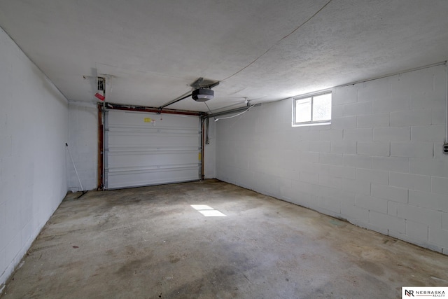 2725 Monroe St, Omaha, NE 68107 - garage with concrete block wall and a garage door opener