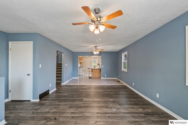2725 Monroe St, Omaha, NE 68107 - unfurnished living room featuring stairway, ceiling fan, baseboards, and wood finished floors