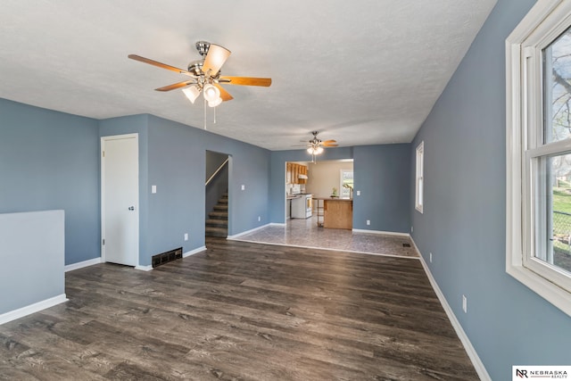 2725 Monroe St, Omaha, NE 68107 - unfurnished living room featuring stairway, wood finished floors, visible vents, a ceiling fan, and baseboards