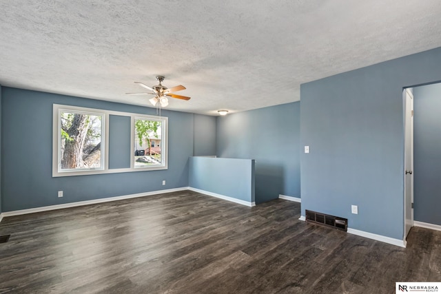 2725 Monroe St, Omaha, NE 68107 - empty room featuring wood finished floors, visible vents, a ceiling fan, baseboards, and a textured ceiling
