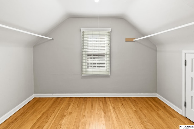 walk in closet with wood finished floors and lofted ceiling