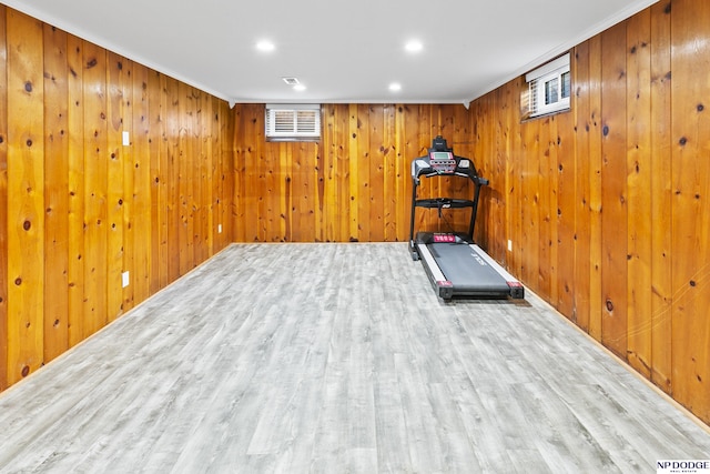 exercise area featuring recessed lighting, wood finished floors, and wooden walls