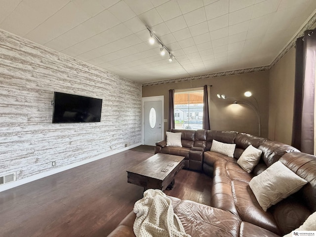 living room with wood finished floors, baseboards, and rail lighting