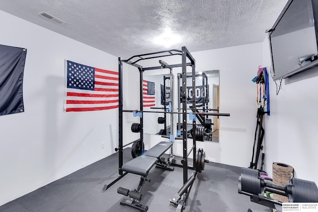 workout room featuring a textured ceiling and visible vents