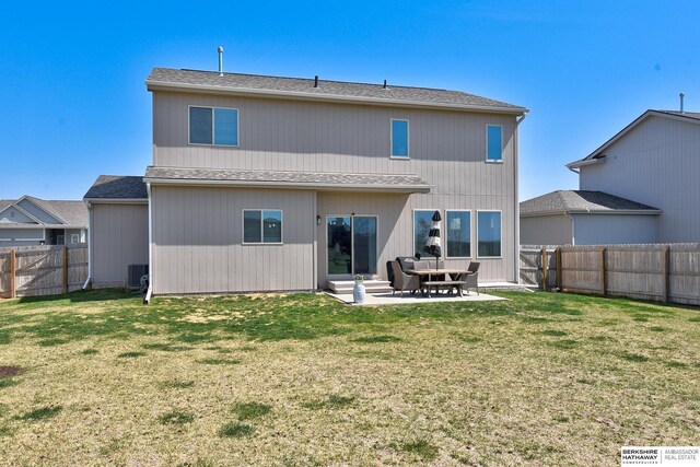 back of property with a fenced backyard, a patio area, and a lawn
