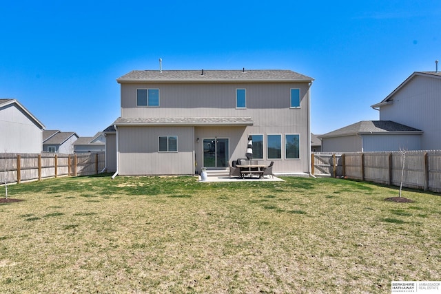 back of house with a lawn, a patio area, and a fenced backyard