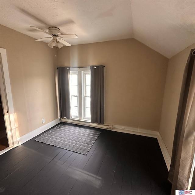 unfurnished room with hardwood / wood-style flooring, ceiling fan, vaulted ceiling, and baseboards