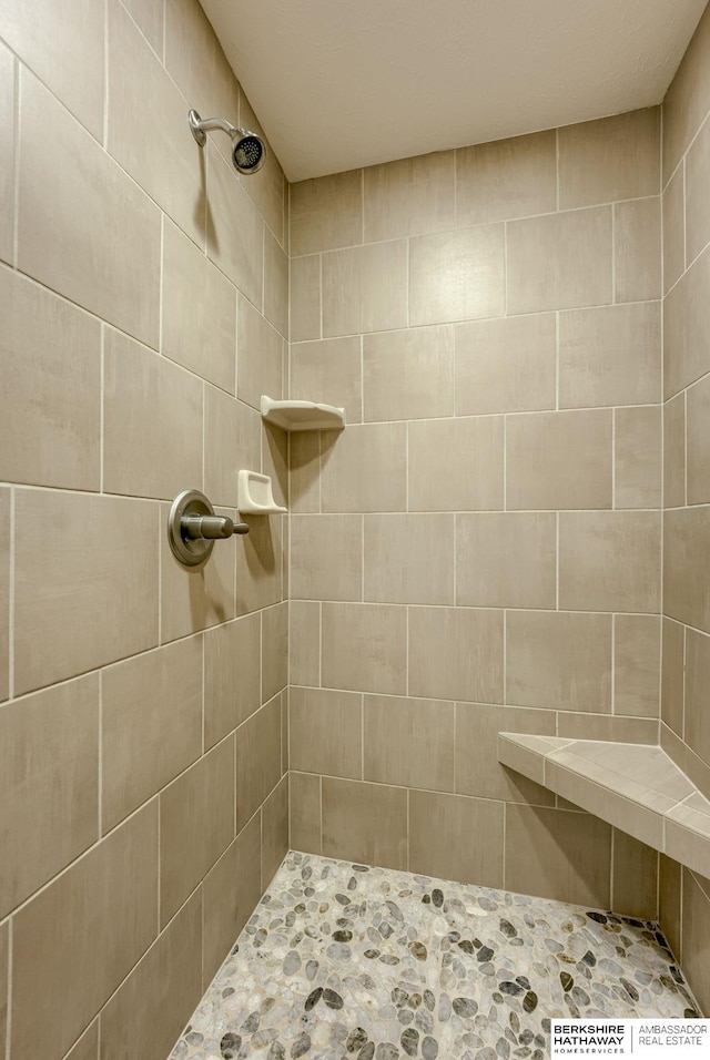 bathroom with a tile shower