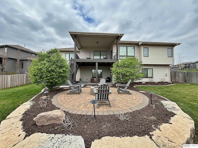 back of property featuring stairs, fence, a yard, a patio, and an outdoor fire pit