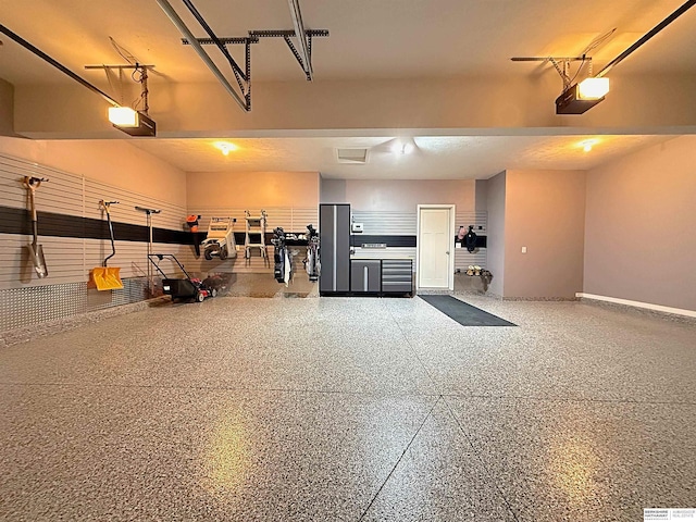garage featuring baseboards and a garage door opener