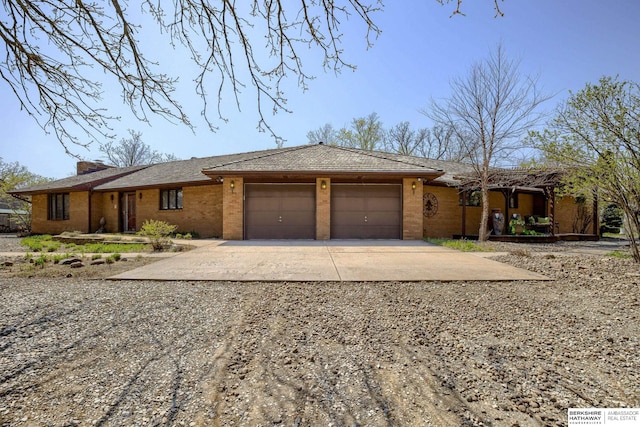 30238 Nixon Dr, Honey Creek, IA 51542 - ranch-style house featuring concrete driveway, brick siding, and a garage