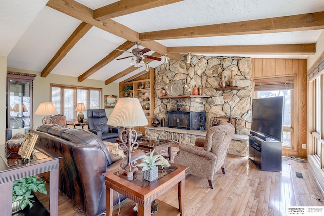 30238 Nixon Dr, Honey Creek, IA 51542 - living area featuring a fireplace, light wood finished floors, lofted ceiling with beams, and a ceiling fan