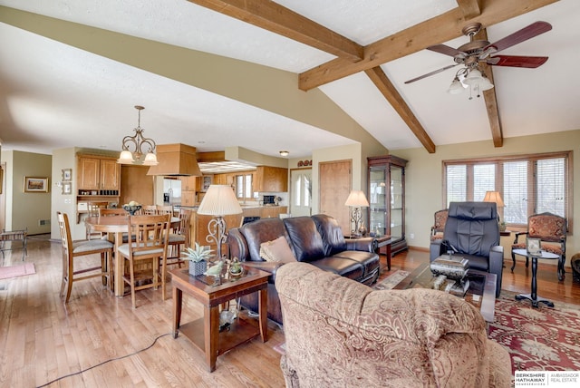 30238 Nixon Dr, Honey Creek, IA 51542 - living room with light wood-style floors, a ceiling fan, baseboards, and vaulted ceiling with beams