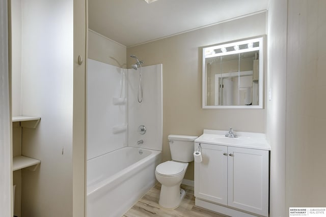 full bathroom featuring shower / bathing tub combination, wood finished floors, toilet, and vanity