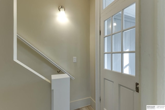 doorway to outside featuring baseboards