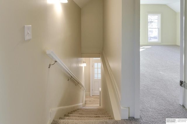 stairs featuring carpet floors, lofted ceiling, and baseboards