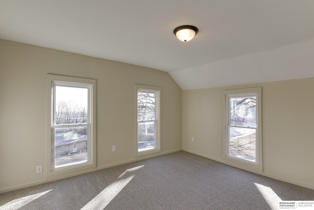 bonus room featuring lofted ceiling, baseboards, and carpet