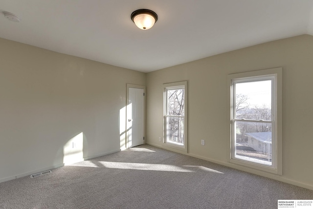 empty room featuring baseboards, carpet flooring, and visible vents