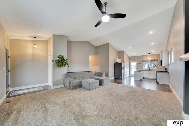 living area with dark colored carpet, baseboards, visible vents, lofted ceiling, and ceiling fan