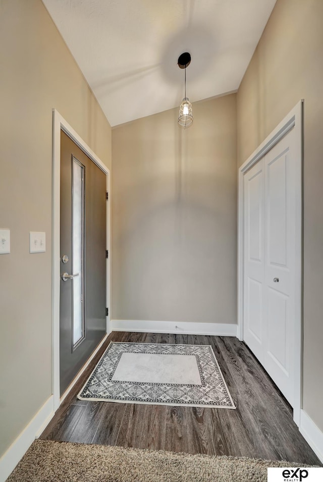 interior space featuring baseboards and wood finished floors