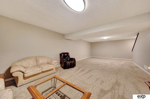 carpeted living room featuring a textured ceiling and baseboards