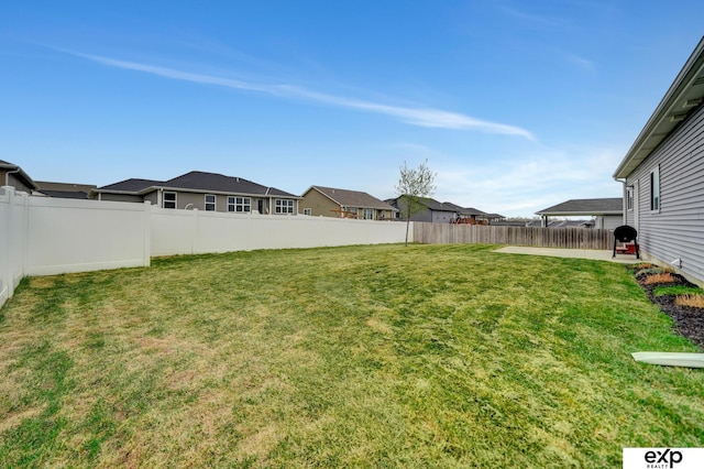 view of yard with a fenced backyard and a residential view