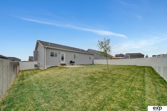back of property featuring a fenced backyard, a patio area, entry steps, and a lawn