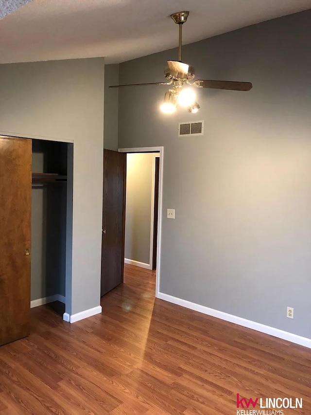 unfurnished bedroom featuring baseboards, wood finished floors, and visible vents