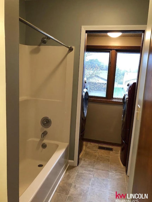 full bath featuring  shower combination, baseboards, washer / clothes dryer, and visible vents
