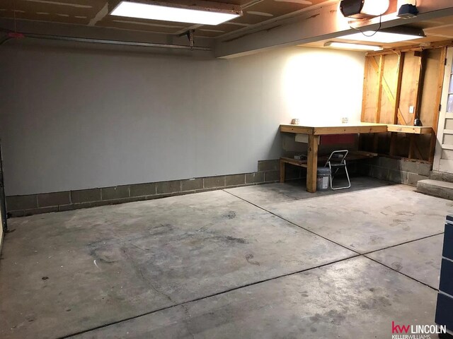 garage featuring a workshop area and a garage door opener
