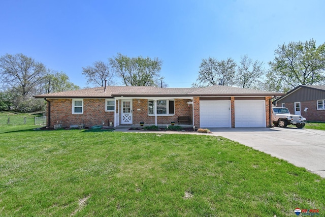 ranch-style home featuring an attached garage, a front lawn, brick siding, and concrete driveway