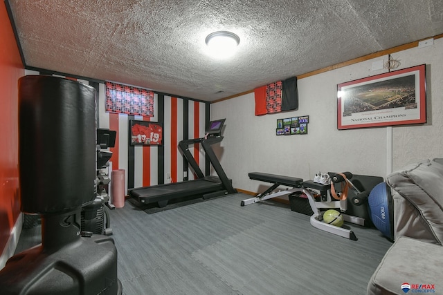 workout room featuring a textured ceiling