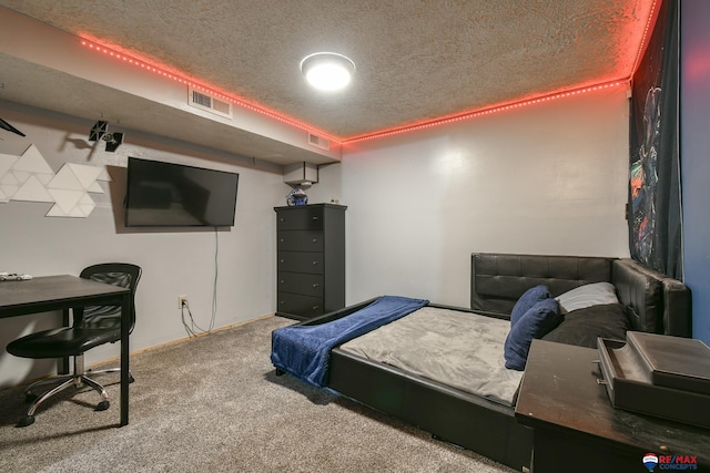 bedroom featuring carpet floors, a textured ceiling, and visible vents