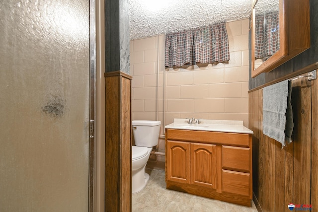 bathroom with vanity, a shower stall, and toilet