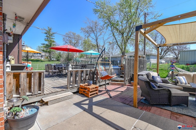 view of patio with fence, a wooden deck, an outdoor hangout area, and outdoor dining area