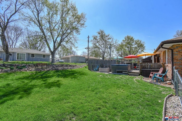 view of yard featuring a hot tub and fence