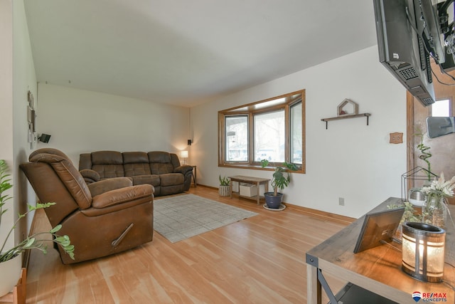 living room featuring wood finished floors and baseboards