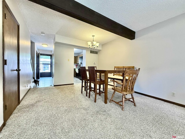2219 Southwood Pl, Lincoln, NE 68512 - carpeted dining room featuring a textured ceiling, a chandelier, beam ceiling, and baseboards