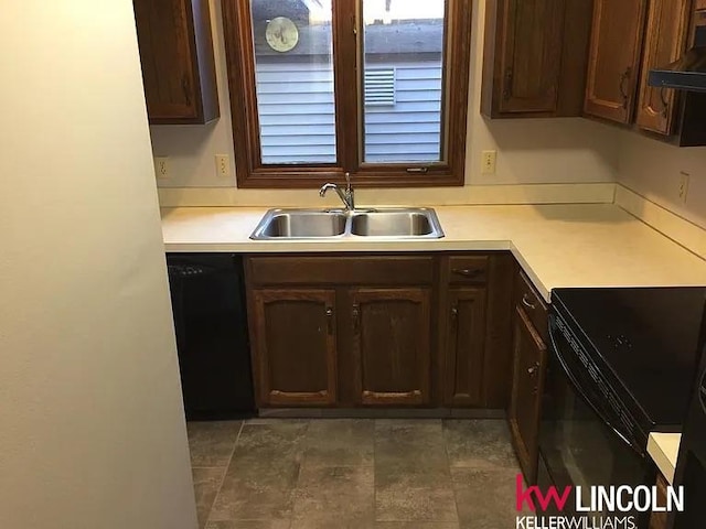 2219 Southwood Pl, Lincoln, NE 68512 - kitchen featuring a sink, dark brown cabinetry, black appliances, light countertops, and under cabinet range hood