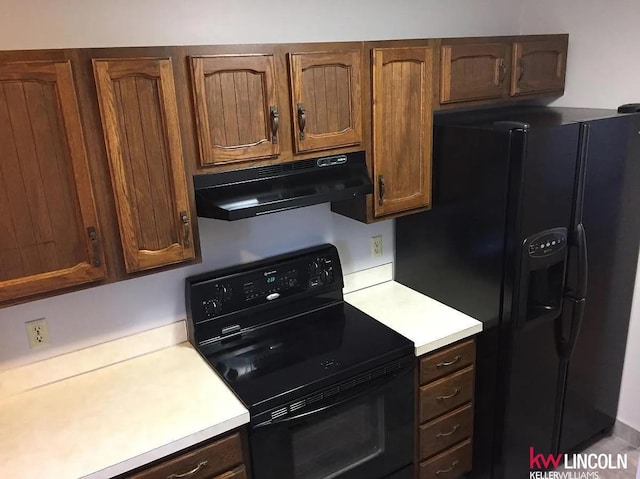 2219 Southwood Pl, Lincoln, NE 68512 - kitchen featuring under cabinet range hood, black appliances, and light countertops