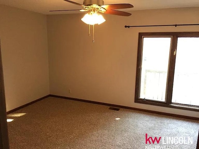 2219 Southwood Pl, Lincoln, NE 68512 - empty room featuring a ceiling fan, carpet floors, and baseboards