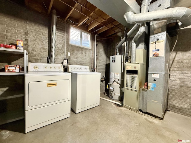 2219 Southwood Pl, Lincoln, NE 68512 - laundry area featuring washer and dryer, gas water heater, heating unit, and brick wall