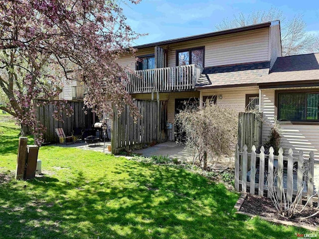 2219 Southwood Pl, Lincoln, NE 68512 - back of property with a balcony, a patio area, and roof with shingles