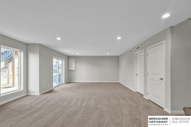 below grade area with recessed lighting, baseboards, and light carpet