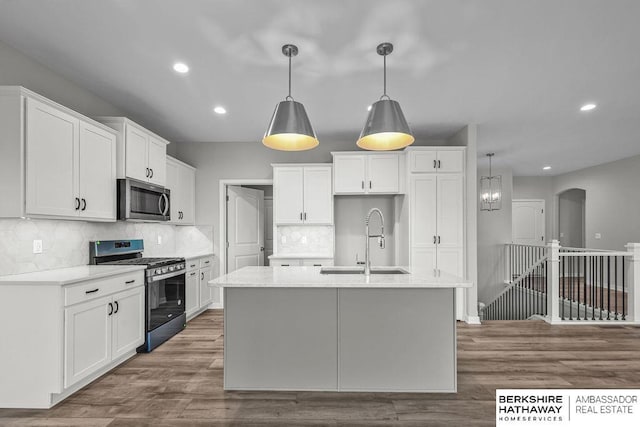 kitchen with recessed lighting, appliances with stainless steel finishes, decorative backsplash, and a sink