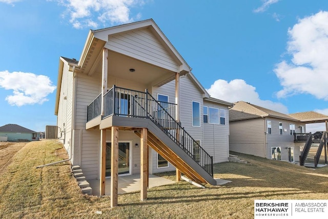 rear view of house with a patio area, a lawn, stairs, and a deck