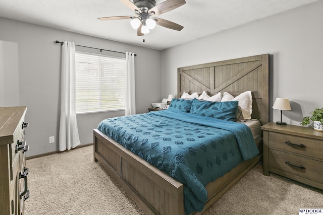 bedroom featuring ceiling fan, light carpet, and baseboards